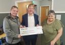 Sam Browning, community champion at Morrisons and Paul Bristow MP, presenting the donation of £10,500 to Evelyn Speechley of Chestnuts Community Centre
