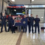 Gordon with Red Watch and the National Fire Service flag.