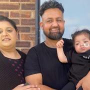 Seven barber Usman with his wife Aliya and his daughter Ayat.