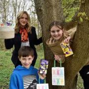 Jake and Isabel Hall with Bellway sales advisor Katie Brown at the Easter egg hunt held at the Elder Brook development in Peterborough.