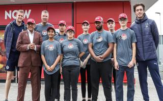Peterborough United goalkeepers Nicholas Bilokapic and Fynn Talley with the owner and staff of the new Wendy's restaurant on Maskew Avenue in Peterborough.